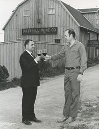 Two men toasting red wine